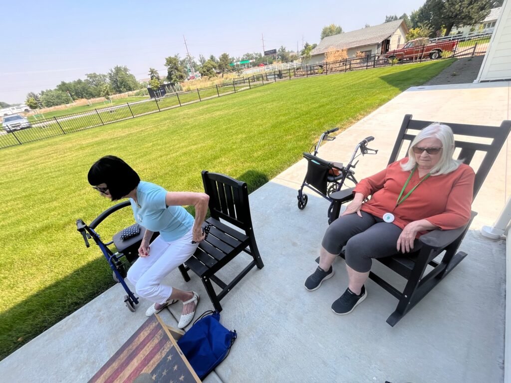 Two Residents relaxing together on the porch at The Ponderosa Estate in Eagle, Idaho