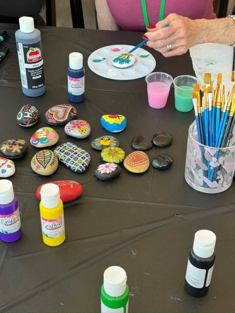 A Resident painting rocks during a craft activity at The Ponderosa Estate