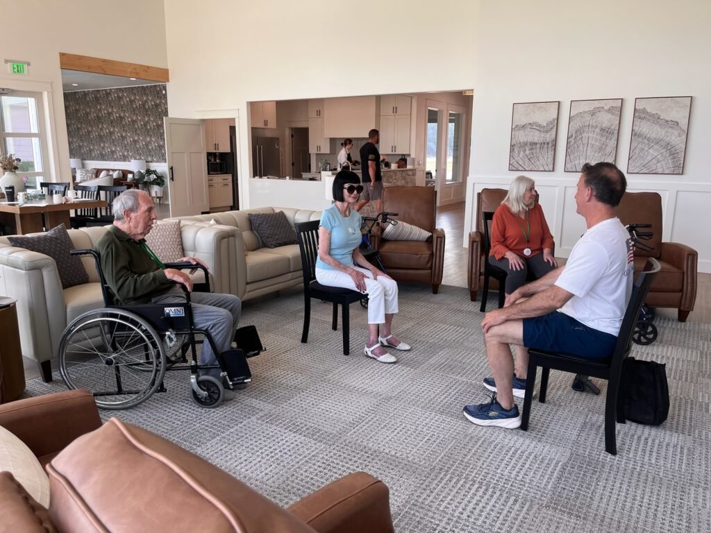 Residents visiting together in the common living area at The Ponderosa Estate
