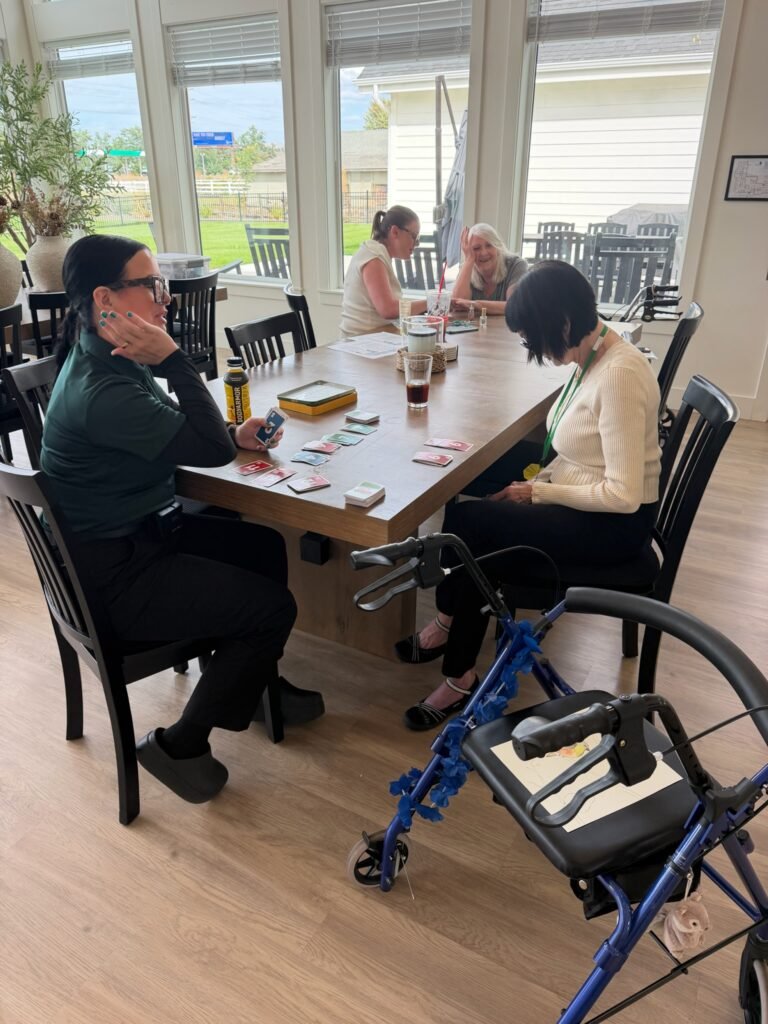 Family members and residents visiting together in the sunroom at The Ponderosa Estate assisted living community
