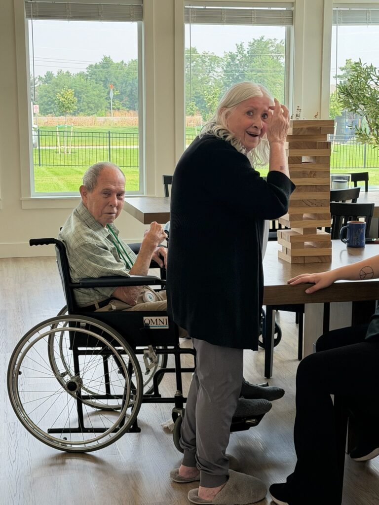 Residents share a lighthearted moment while playing a game together at The Ponderosa Estate.