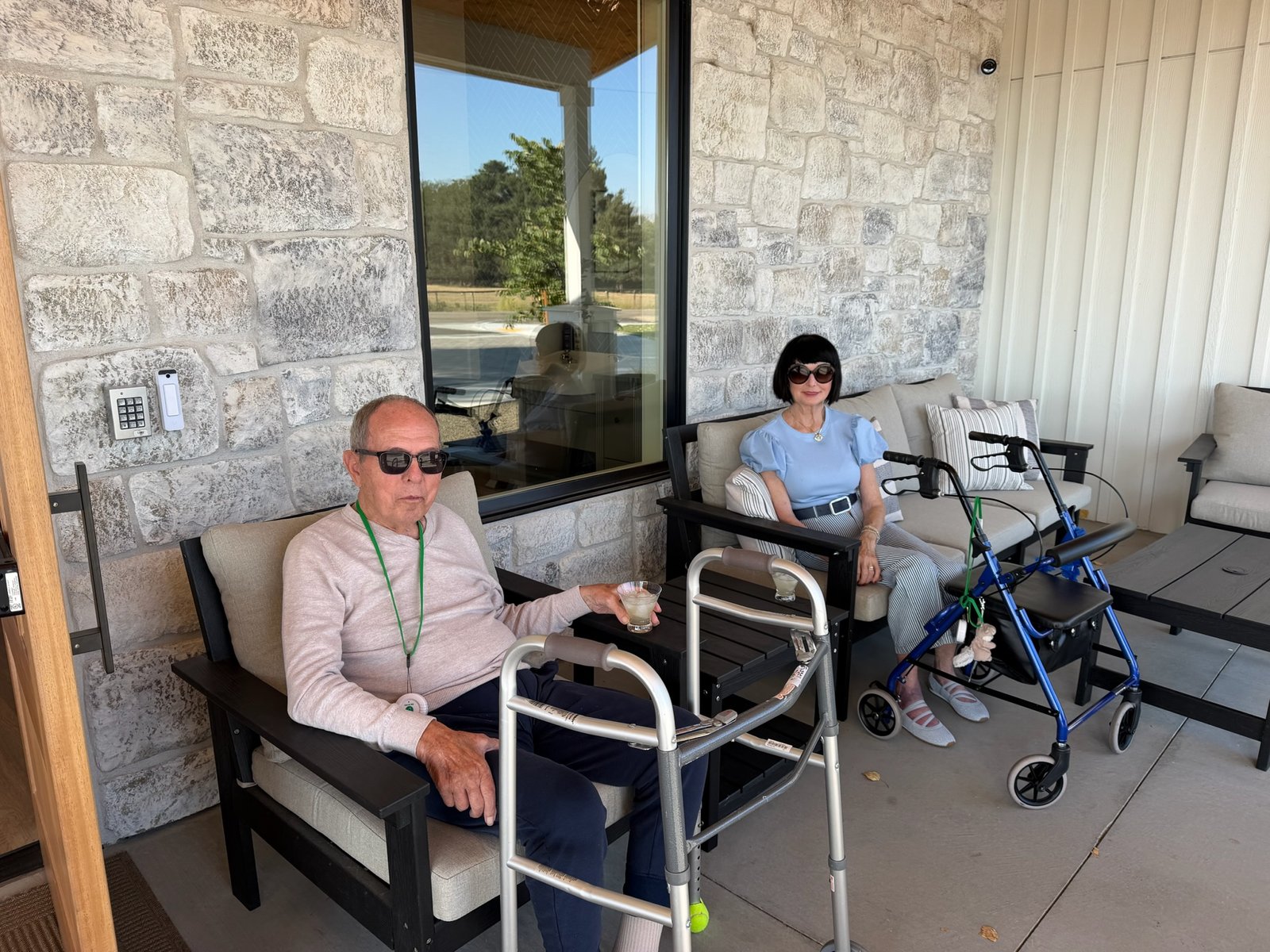 Residents relaxing together on a porch at The Ponderosa Estate assisted living community