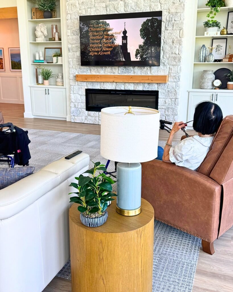 A Resident relaxing in the living room at The Ponderosa Estate during a cozy indoor movie afternoon
