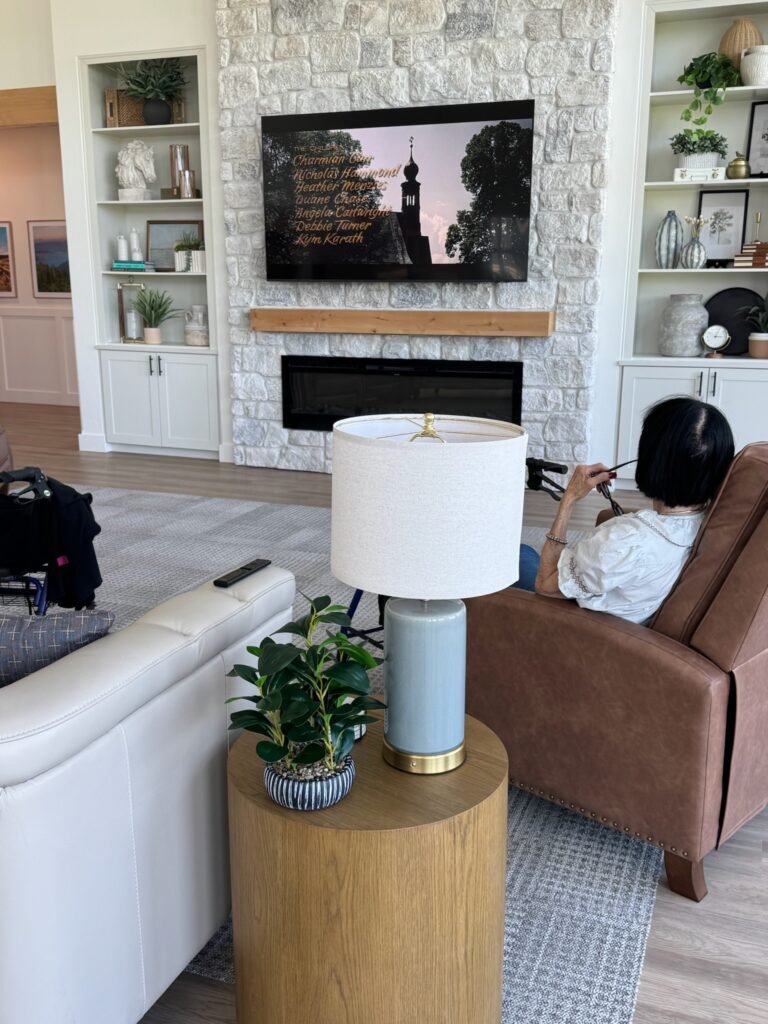 A Resident relaxing in a leather recliner by the stone fireplace in the great room at The Ponderosa Estate in Eagle, Idaho