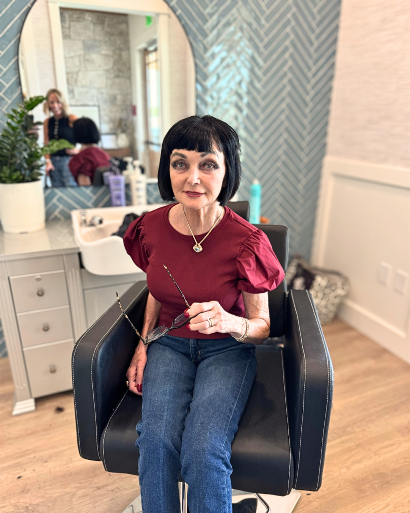 Resident with a fresh black bob haircut seated in the on-site salon at The Ponderosa Estate