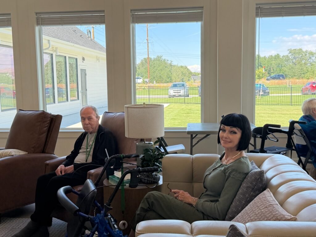 Residents relaxing together in the bright sunroom lounge at The Ponderosa Estate assisted living in Idaho